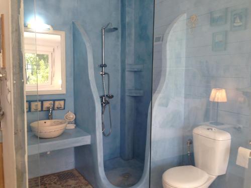 a bathroom with a shower and a toilet and a sink at LEMONELIA, one big,4-5 people and one small apartment ,2-3 people in Loutsa