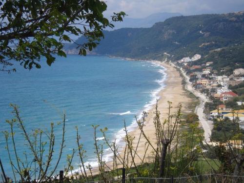 a view of a beach with a town and the ocean at LEMONELIA, one big,4-5 people and one small apartment ,2-3 people in Loutsa