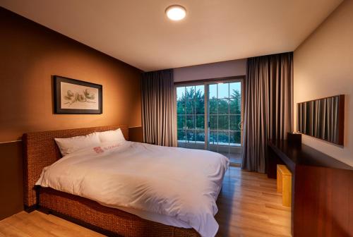 a bedroom with a bed and a large window at Eldorado Resort in Sinan