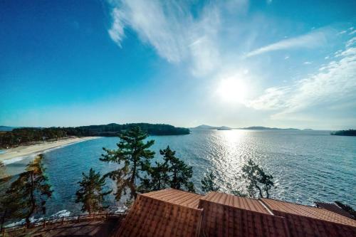 a view of a beach and the sun on the water at Eldorado Resort in Sinan