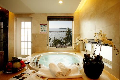 Eldorado Resort في Sinan: حمام مع حوض استحمام مع نافذة
