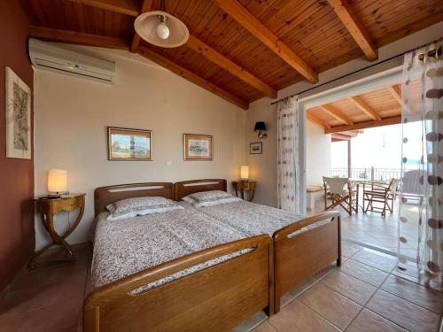 a bedroom with a large bed in a room at Ermioni Sea View Villa in Ermioni