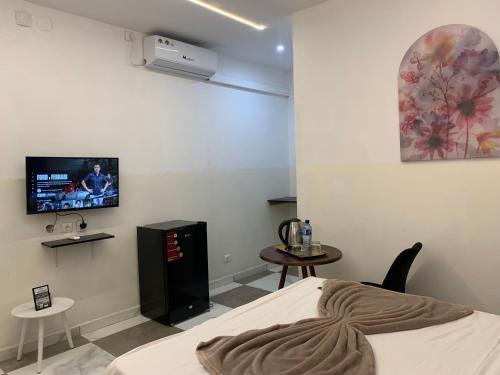 a bedroom with a bed and a tv on the wall at 40 40 Accommodation in Matola