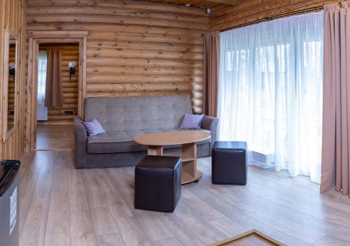 a living room with a couch and a table at Meguva Resort Hotel in Palanga