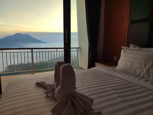 a bedroom with a bed with a view of a mountain at Batur view Homestay - Loft in Kintamani
