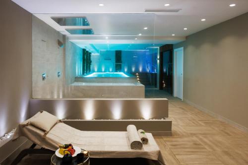a bathroom with a large mirror and a tub at Alanda Marbella Hotel & Wellness in Marbella