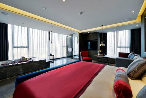 a bedroom with a large bed and a living room at Mehood Elegant Hotel Xi'an Big Wild Goose Pagoda Tang Dynasty City in Xi'an