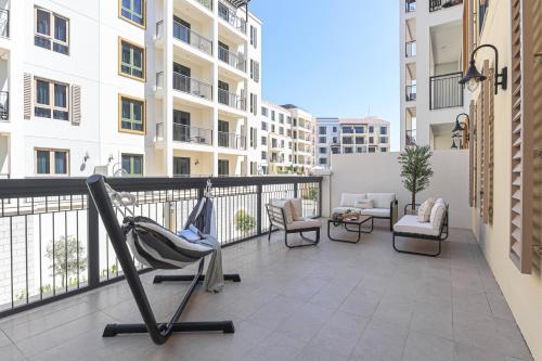 a balcony with a chair and furniture on a building at HiGuests - Luxurious Boho Beach 2BR Apartment in La Mer in Dubai