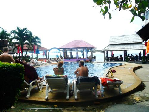 a group of people sitting in chairs in a pool at Lanta New Beach Bungalows - SHA Plus in Ko Lanta