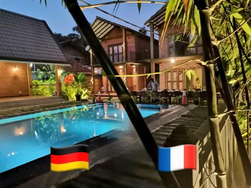 a villa with a swimming pool at night at MILLET'S FOOD COMPANY AND COOKING CENTER in Negombo