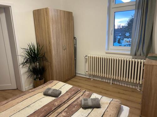 a bedroom with a large bed and a window at Vila Lomnička in Vysoke Tatry - Tatranska Lomnica.