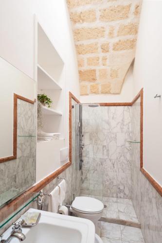 a bathroom with a toilet and a sink at B&B Corte Dei Taralli in Lecce