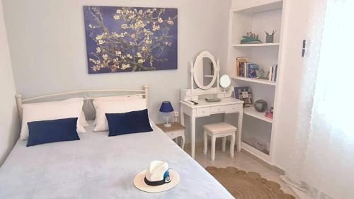 a bedroom with a bed with a hat on it at DION'S HOME with Private Parking at the Center of Kos Town in Kos
