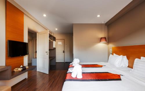 a bedroom with a white teddy bear sitting on a bed at The Cottage Suvarnabhumi in Lat Krabang