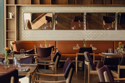 a restaurant dining room with tables and chairs at PURO Hotel Poznań Stare Miasto in Poznań