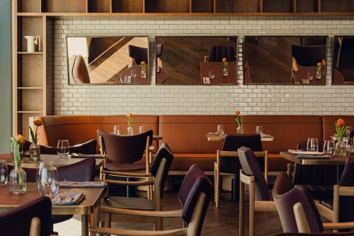 a restaurant dining room with tables and chairs at PURO Poznań Stare Miasto in Poznań