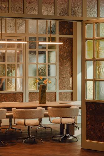 a room with a table and chairs and windows at PURO Hotel Poznań Stare Miasto in Poznań