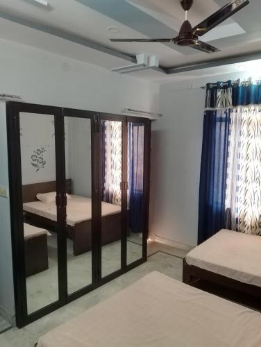 una camera con 2 letti e un ventilatore a soffitto di Comfort Inn Guesthouse a Jaipur