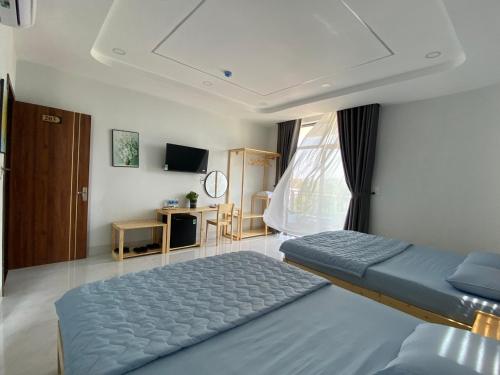 a bedroom with a large bed and a window at Windy Homestay Phan Thiết in Phan Thiet