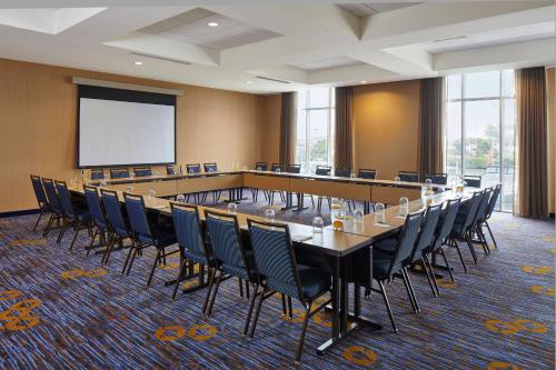 a large conference room with a long table and chairs at Courtyard by Marriott St. Petersburg Clearwater/Madeira Beach in St Pete Beach