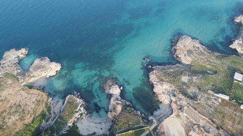 an aerial view of the ocean and rocks at Loft 900 - Home & SPA - A Timeless Luxury in Monopoli in Monopoli