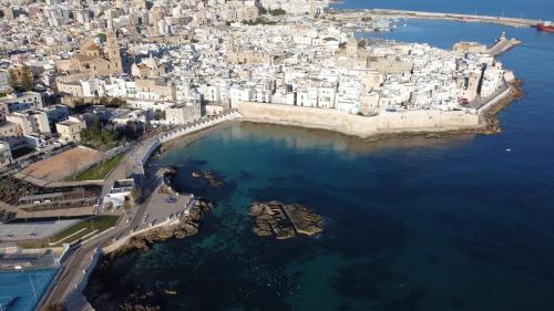 an aerial view of a city with buildings and the water at Loft 900 - Home & SPA - A Timeless Luxury in Monopoli in Monopoli
