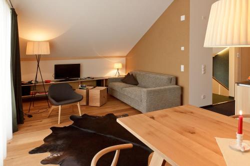 a living room with a couch and a table at Arlberg Lodges in Stuben am Arlberg