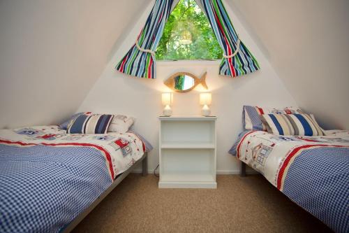 a bedroom with two twin beds and a window at Chalet Fiftynine in Deal