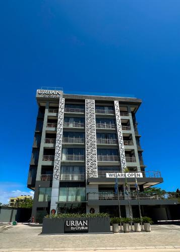 a building with a sign on the front of it at Urban by CityBlue Hotel, Dar es Salaam in Dar es Salaam