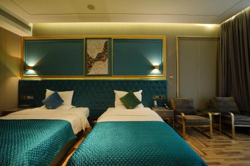 a hotel room with two beds and a chair at Mehood Hotel Shanghai Lujiazui in Shanghai