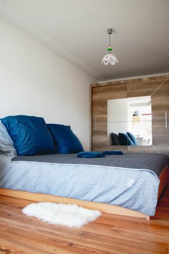 a bedroom with a large bed with a mirror at Contact Apartman in Bardejov