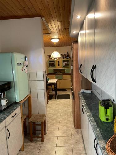 a kitchen with a counter and a table in it at Stupa-Rezi-Tatika-Haz in Zalaszántó