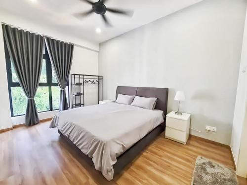 a bedroom with a bed and a ceiling fan at The Cove Hillside Residence Ipoh in Ipoh