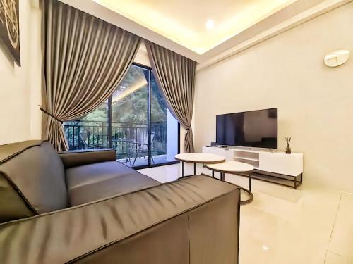 a living room with a couch and a television at The Cove Hillside Residence Ipoh in Ipoh