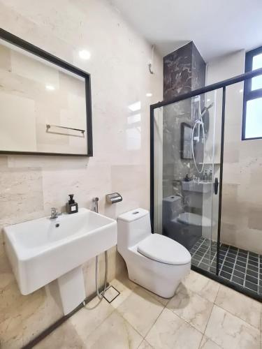 a bathroom with a sink and a toilet and a shower at The Cove Hillside Residence Ipoh in Ipoh