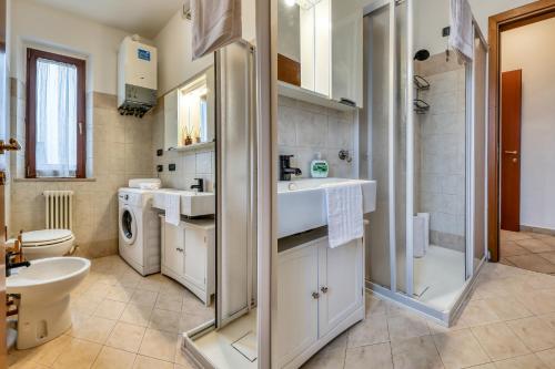 a bathroom with a sink and a toilet and a shower at Il Conero Bilocale con posto auto privato in Osimo
