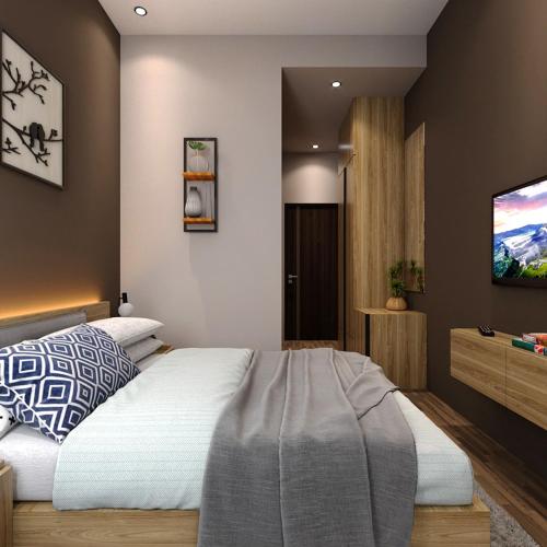 - une chambre avec un lit et une télévision murale dans l'établissement Sajiwa Inn and Suite Hotel, à Jepara