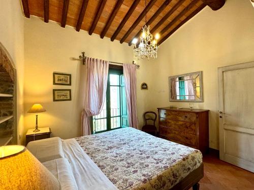 a bedroom with a bed and a dresser and a window at Agriturismo Monteverde in Castelnuovo Magra