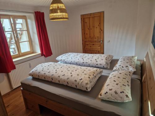 a bedroom with two beds with pillows on it at Sonnseitn FW in Bad Heilbrunn