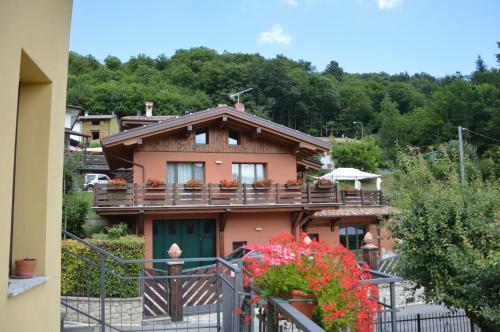 a house with a balcony with flowers on it at B&B La Piazzetta in Castiglione dei Pepoli