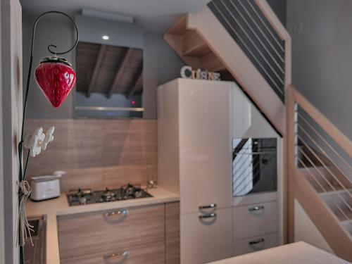 a kitchen with a staircase and a refrigerator at Loft Civico 12 in Pian Camuno