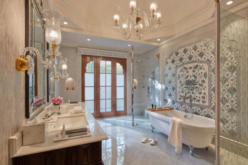 a bathroom with a tub and a sink and a mirror at Mementos by ITC Hotels Jaipur in Jaipur