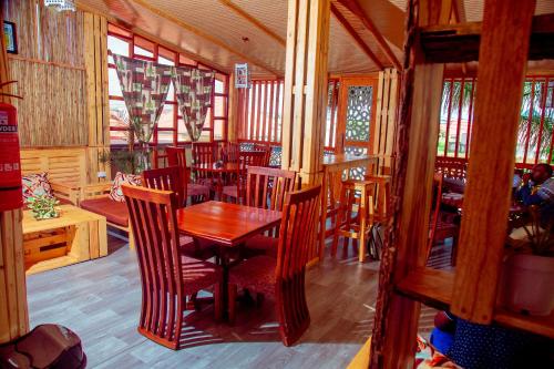 a dining room with a wooden table and chairs at WILLOW INN in Dodoma