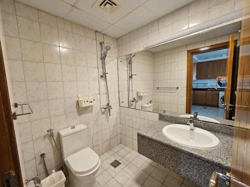 a bathroom with a toilet and a sink at Vibrant,affordable Apt 5 Minutes From Metro in Dubai