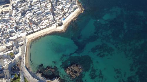 an aerial view of a group of buildings and the ocean at Loft 900 - Home & SPA - A Timeless Luxury in Monopoli in Monopoli