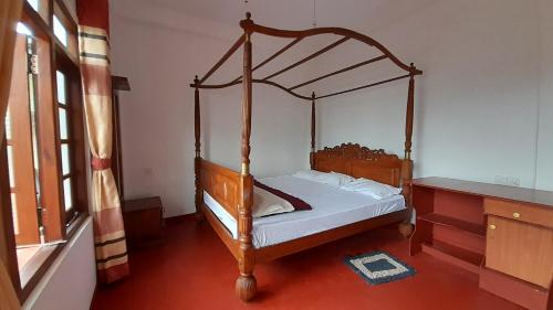 uma cama num quarto com uma cama de madeira em Royal Rich Bungalow Maskeliya em Maskeliya