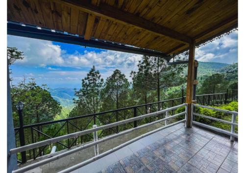 a balcony with a view of the mountains at Stoneshed Resort And Hotel in Nainital