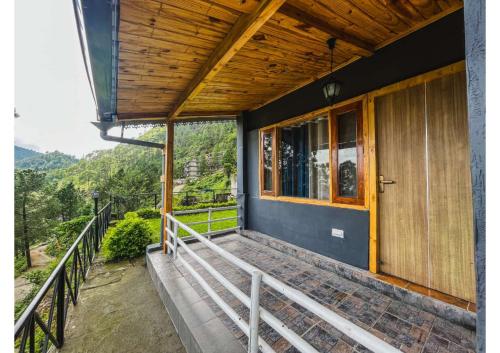 a porch of a house with a balcony at Stoneshed Resort And Hotel in Nainital
