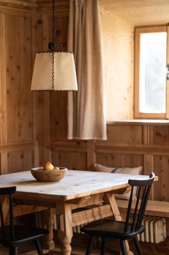 a wooden table with a bowl of fruit on it at Wassermann in Sesto