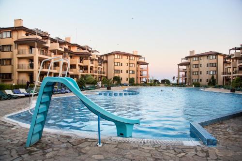 a slide in a swimming pool in a apartment complex at Kaliakria Resort in Topola